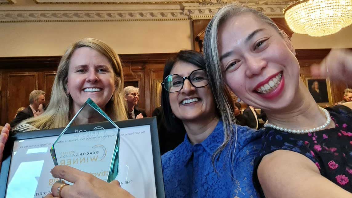 Fumiko, Savi and their colleague celebrate their Beacon Award.
