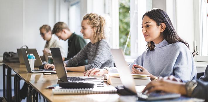 Students using laptops in class.