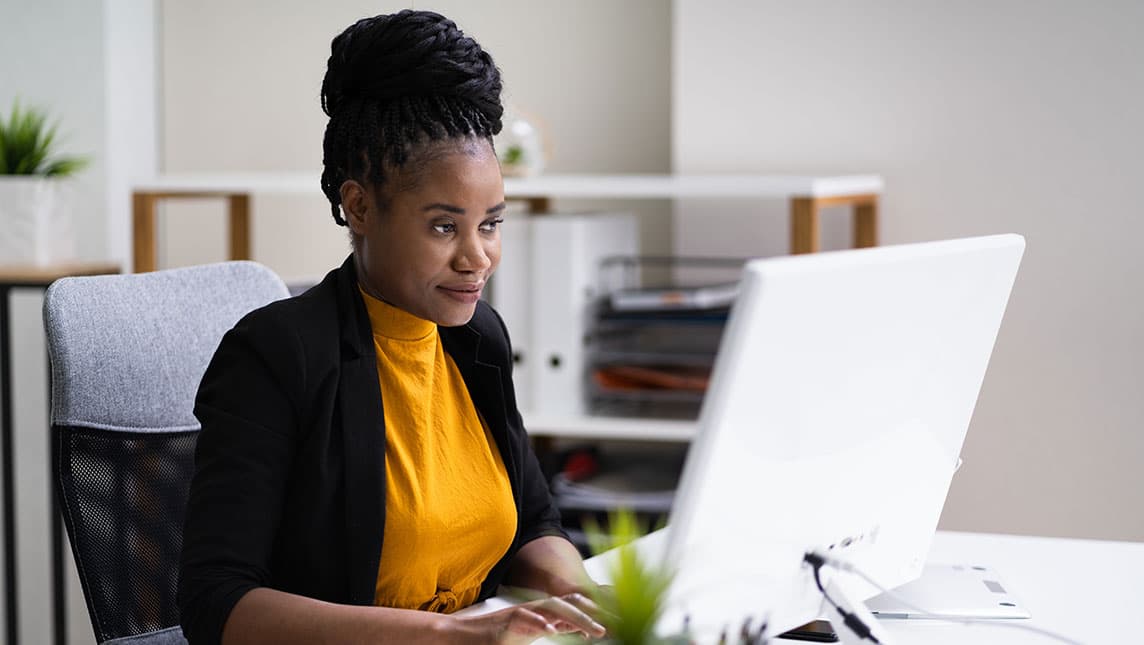 A researcher workers at a laptop.