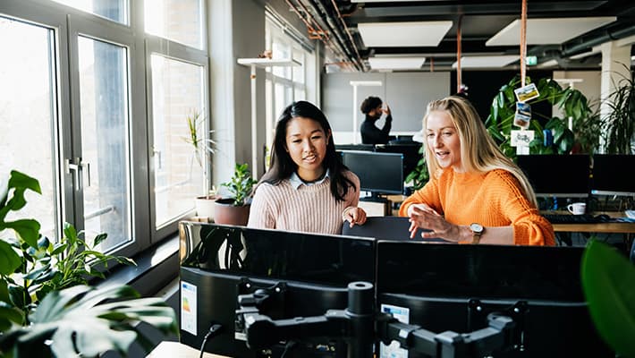 Two women looking at a computer.