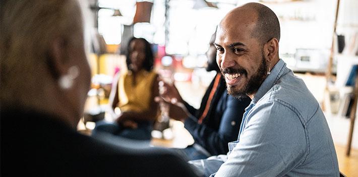 Work colleagues in discussion during a workshop.